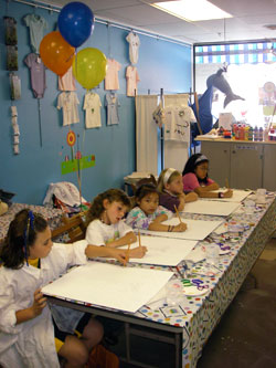 Birthday party table with children painting